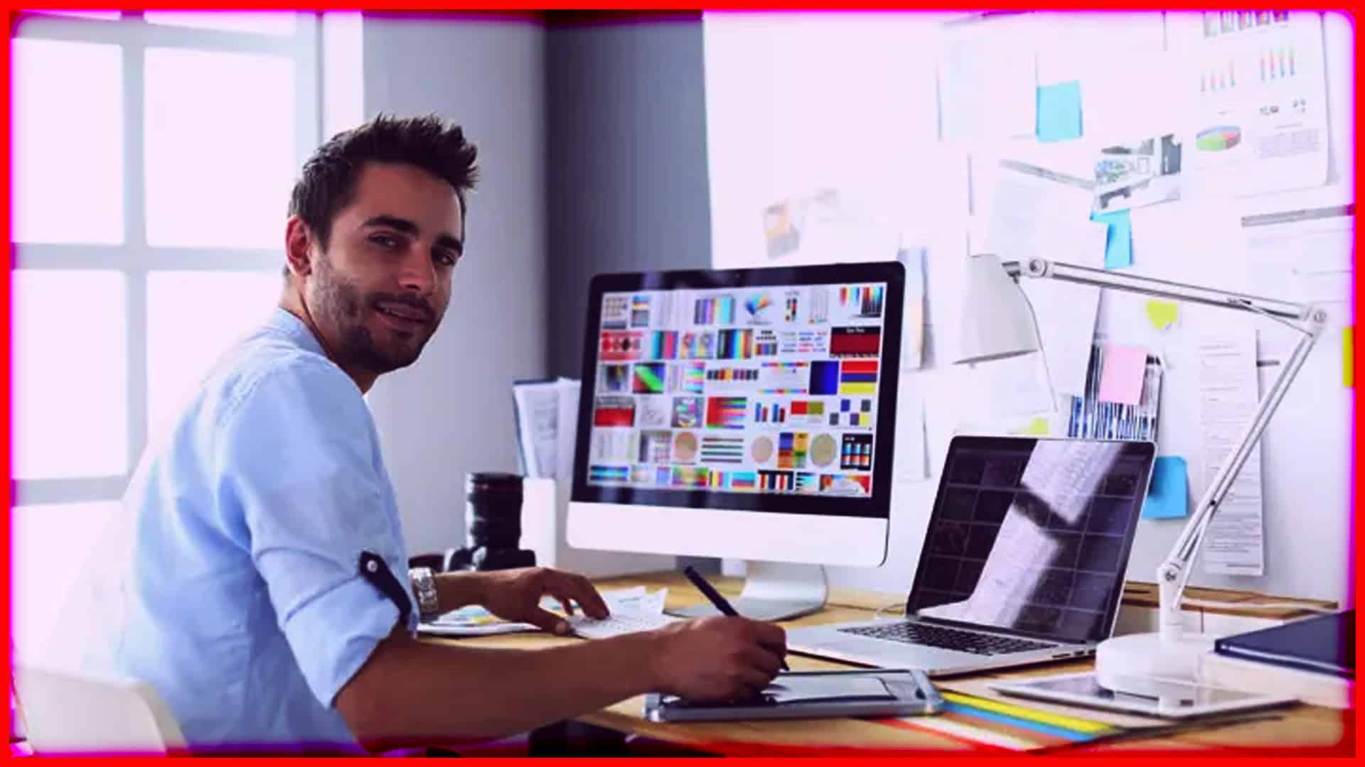 Modern web developer working on website design with multiple screens in a bright office.