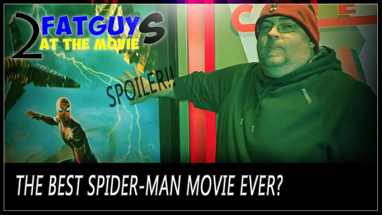 Man pointing at Spider-Man movie poster with spoiler warning.