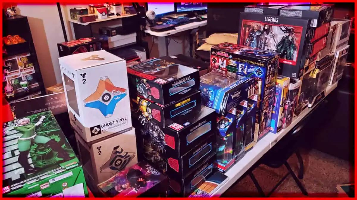 Collection of boxed action figures and collectibles on a cluttered desk.