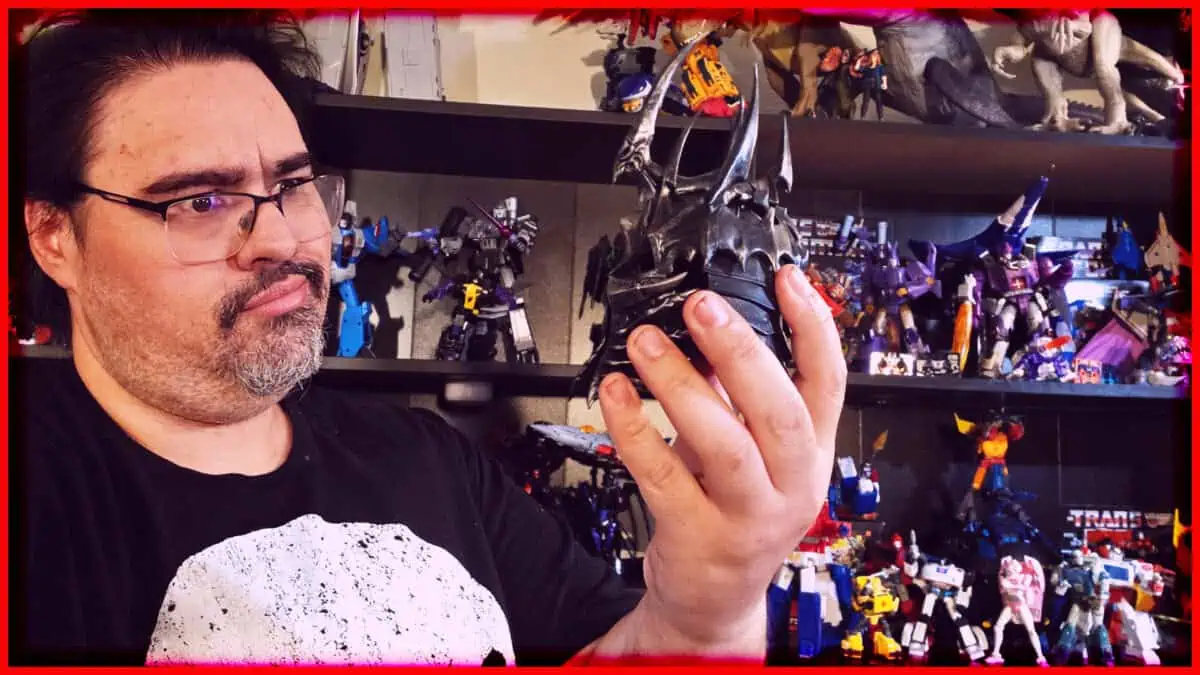 Man examining a detailed action figure in a collection of toys and collectibles.
